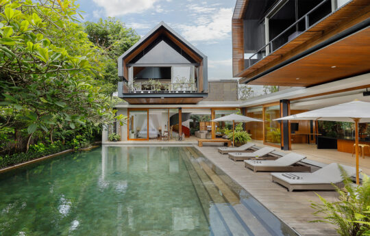 Swimming pool with step in for the kids and luxury villa exterior