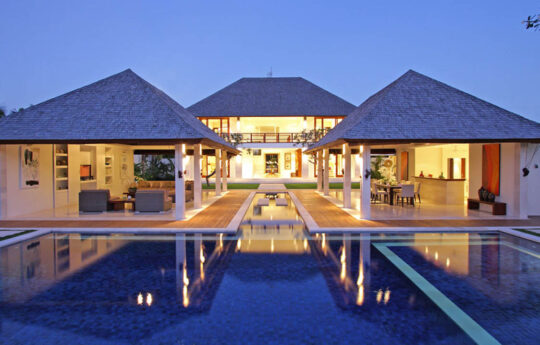 Villa Asante exteriors at night with swimming pool