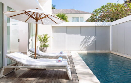 swimming pool of villa with day beds