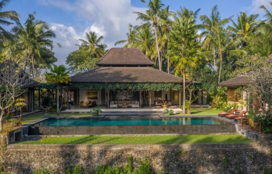 Villa Crystal Castle swimming pool and view of entire villa under Ubud sky