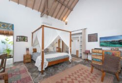 Modern bedroom with high ceiling and king size bed with mosquito net