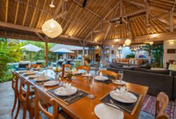 Living and dining areas of villas with garden in background