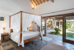 Modern bedroom with queen bed and views of garden