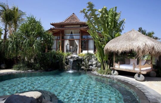 Swimming pool, gazebo and Villa Amy during the day with blue skies