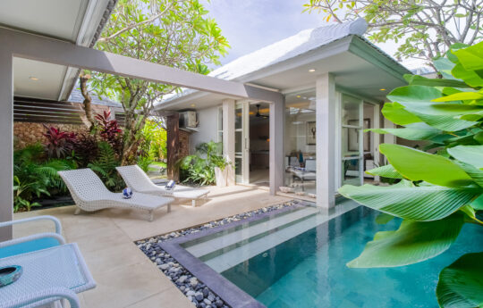 swimming pool with day beds and villa exteriors of Villa White Pearl