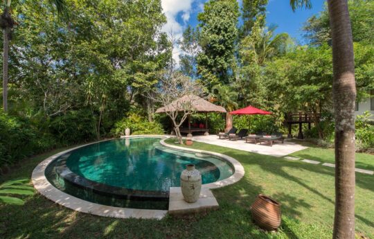 Swimming pool and garden with bali style gazebo in background