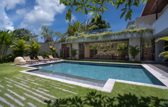 Swimming pool and villa's exterior vistas with garden and tress