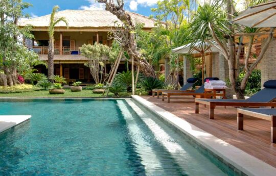 swimming pool with stairs to walk in with villa exterior