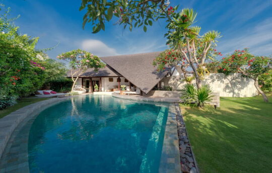 Swimming pool or tropical bali villa in Seminyak on sunny day with villa in background