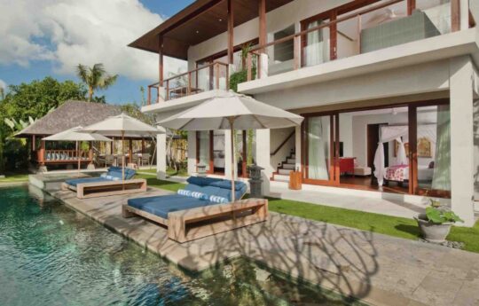 View of swimming pool and garden area from lounge room during day of Villa Joss
