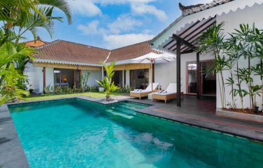 Swimming pool on a sunny day with views to entire villa