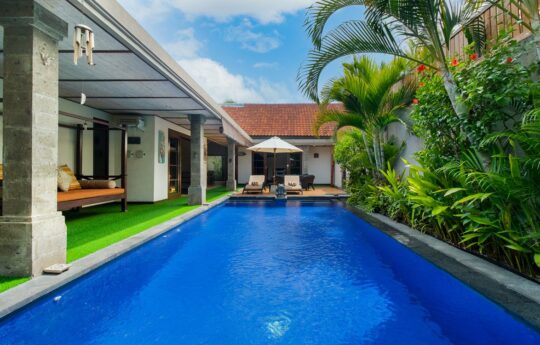 Villa Tranquil entire swimming pool views with daybeds in background during sunny day